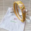 diadema amarilla flores bordadas
